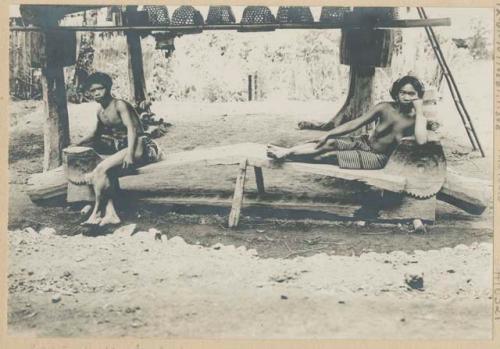Ifugao man and woman sitting on a resting bench