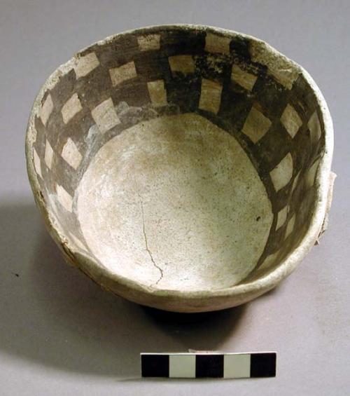 Portion of dipper with handle missing, black on white checkerboard design