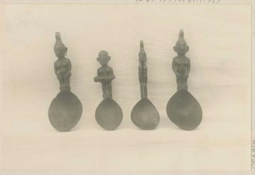 Four carved wooden spoons