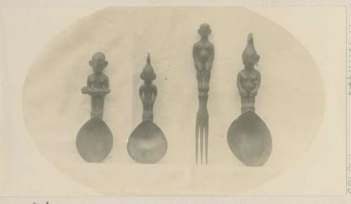 Three carved wooden spoons and a fork