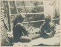 Two Guiangan women polishing cloth made from hemp fiber