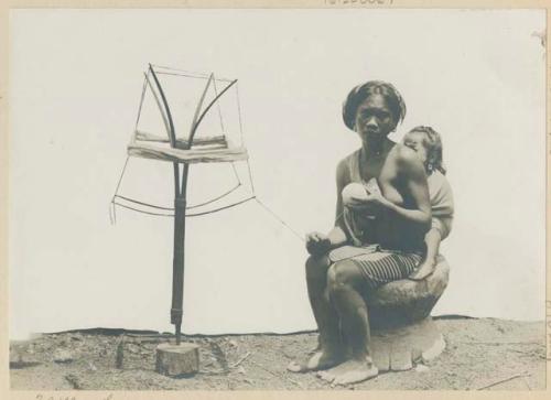 Ifugao woman with child, using a loom