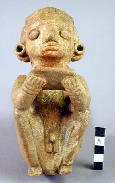 Kneeling male figure, ocarina.