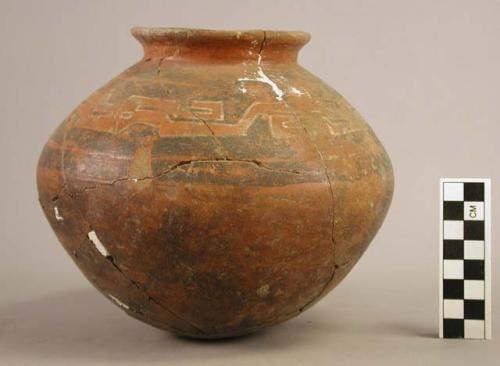 Ocra Polychrome pottery jar with white, black and red and stylized crocodile designs