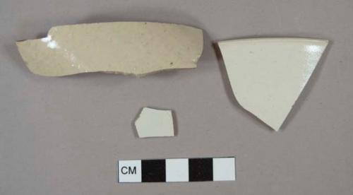 White salt glazed stoneware rim and body sherds; one has incised lines