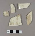 Creamware body and rim sherds; one has incised flower design