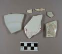 One creamware body sherd; two pearlware body sherds; one pearlware rim sherd; one ironstone complete profile sherd; one porcelain body sherd with pink handpainted overglaze lettering "ker"
