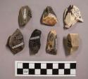 7 flint flakes, including grey, brown, black and cream colored stone (some with cortex)