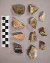 11 flint flakes, including grey, brown, tan and cream colored stone (with cortex)