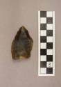 1 flint point, brown colored stone