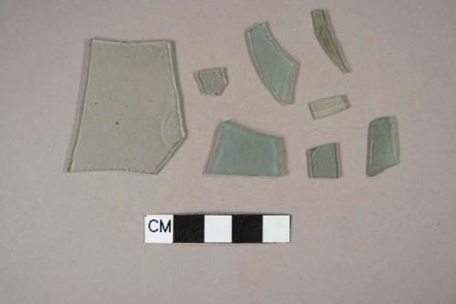 Seven aqua flat glass fragments; one aqua bottle glass fragment