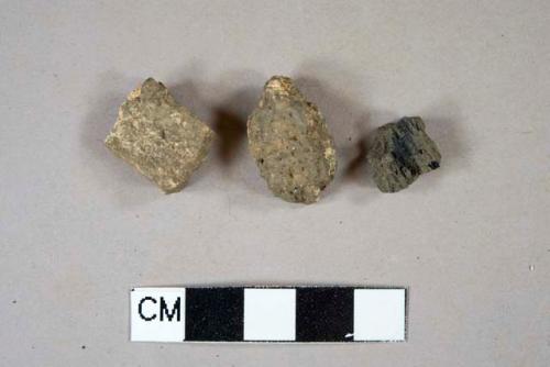 1 charcoal fragment, 2 mortar fragments