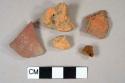 4 red brick fragments, 1 redware body fragment decorated with red and black slip