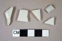 White salt-glazed stoneware, molded body fragments, 1 grey salt glazed stoneware rim fragment, possible Westerwald but undecorated