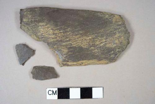 Dark gray slate fragments, likely roofing slate, 2 fragments crossmend