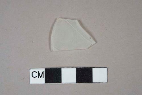 colorless glass vessel body fragment, fully frosted on one side, frosted circles and band decoration on opposing side