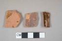 Red lead glazed redware body and rim fragments, rim sherd decorated with molded lines