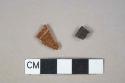Red and dark brown lead-glazed, redware, 1 vessel body fragment, 1 rim fragment, undecorated