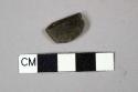 Dark olive green vessel glass fragment, likely bottle glass