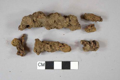 Ferrous metal nail fragments, unidentified ferrous metal fragments, all heavily corroded