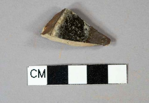 Brown salt-glazed stoneware vessel base fragment, gray paste, burned