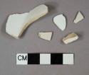 White lead-glazed pearlware vessel body, rim, and base fragments, white paste, undecorated