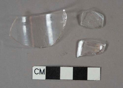 Colorless glass vessel rim and body fragments, possible stemware or jar, ~4.6cm diameter