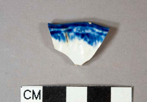 Blue shell-edged pearlware vessel rim fragment, scalloped rim with embossed motif