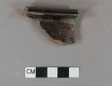 Undecorated lead glazed redware rim sherd, possible chamber pot