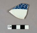 Blue hand painted pearlware rim sherd, molded design on interior, incised line on exterior