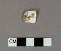 Whiteware rim sherd with gilded stripe around rim