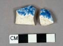 Blue on white transfer decorated whiteware vessel body fragment, leaf motif, both fragments crossmend