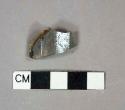 Colorless 12-sided bottle glass body fragment, interior residue or burned