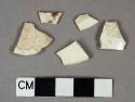 Creamware vessel body fragments, 1 possible rim fragment, 1 with brown sponged decoration, all others undecorated