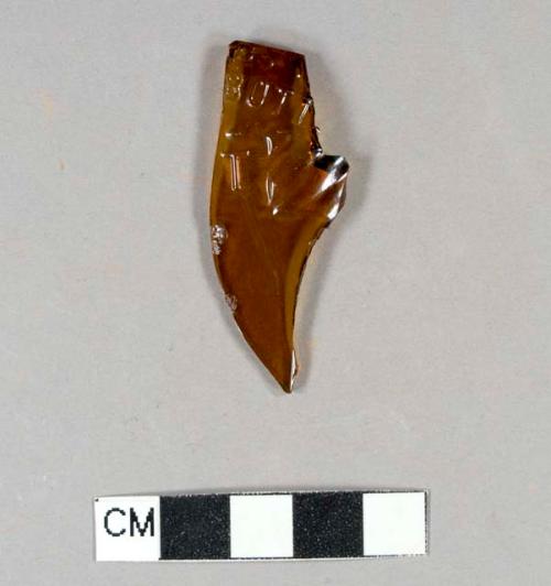 Molded amber bottle glass fragment with embossed letters: "...DSS / BOTT / T..."