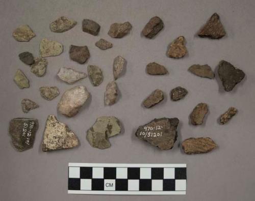 13 pieces unglazed pottery; 7 chips buff-colored material (stone or pottery?); 7