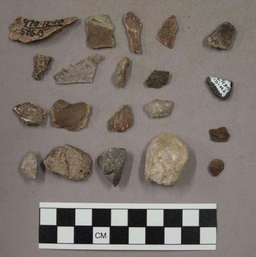 28 stone chips; 13 quartz pieces; 1 fragment unglazed pottery (?); 2 bits wood;