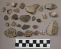 1 piece flint-like rock; 14 pieces unglazed pottery; 1 silver mica; 49 stone chi