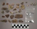 4 fragments bone; 13 tiny charcoal bits; 39 quartz pieces; approx. 225 pieces an