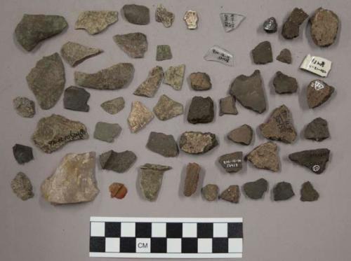 2 partially reconstructed pots, 49 pottery sherds, 3 glass, 2 pottery, chipping