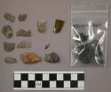 2 pieces rusty nail; piece glass; 2 quartz pieces; 6 pieces coal; 9 pieces stone