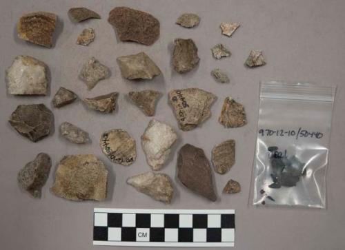 34 quartz pieces; 13 glazed pottery (or stone) pieces (?); approx. 210 stone chi