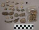 1 piece bone; approx. 150 stones, some small and round with light brown sand; so