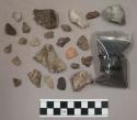 47 stone chips and pieces; 23 pieces quartz; 2 bone (?) pieces; charcoal bits an