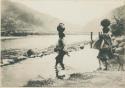 Igorot women carrying water at the river