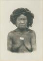 Posed Igorot woman wearing hair switches, possibly of deceased relatives