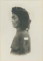 Posed Igorot woman wearing hair switches, possibly of deceased relatives, profile