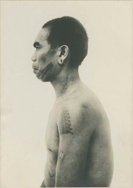 Bontoc Igorot man with tattoo, profile