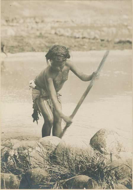 Igorot person preparing rice terrace for planting