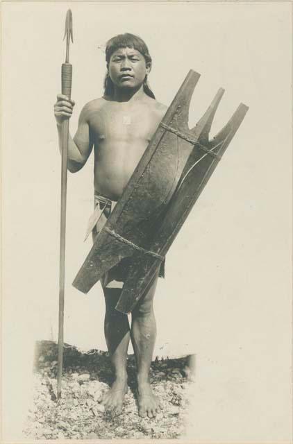 Igorot warrior posed with lance and shield